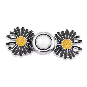 Twin black daisy charms with yellow centers flanking a silver central circle on waist knot hardware.